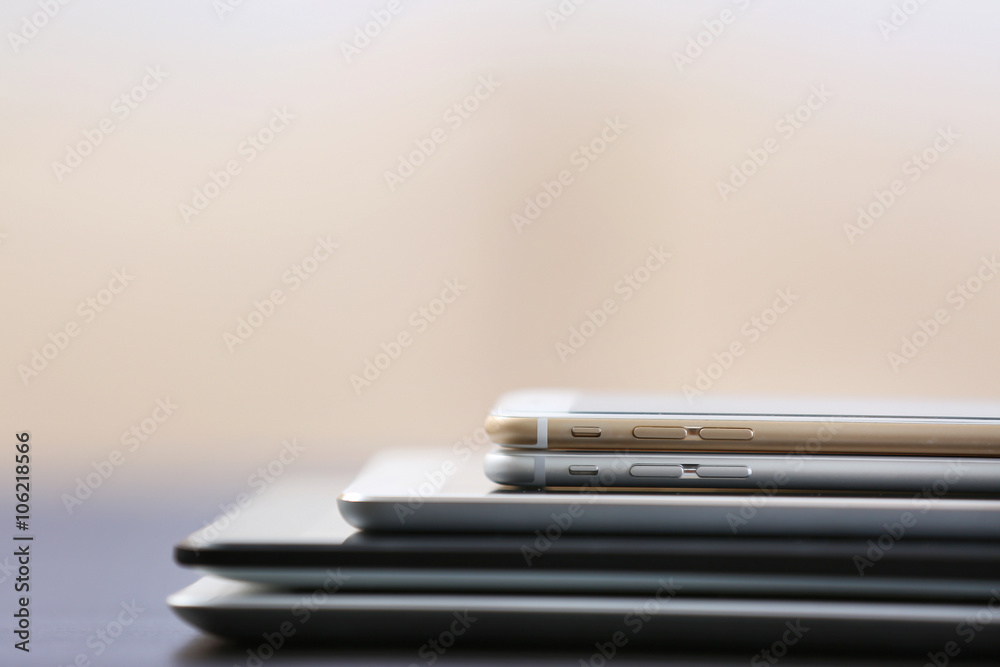 Stack of electronic devices on a dark desk Stack of electronic devices on a dark desk