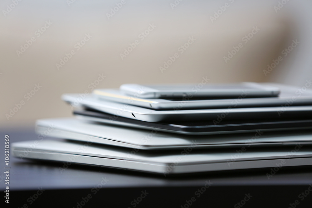 Stack of electronic devices on a dark desk Stack of electronic devices on a dark desk