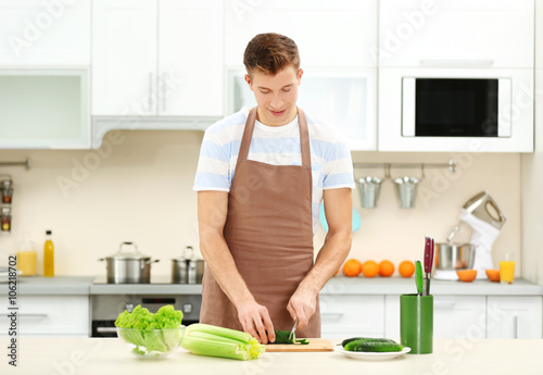 Handsome man cooking in bri...