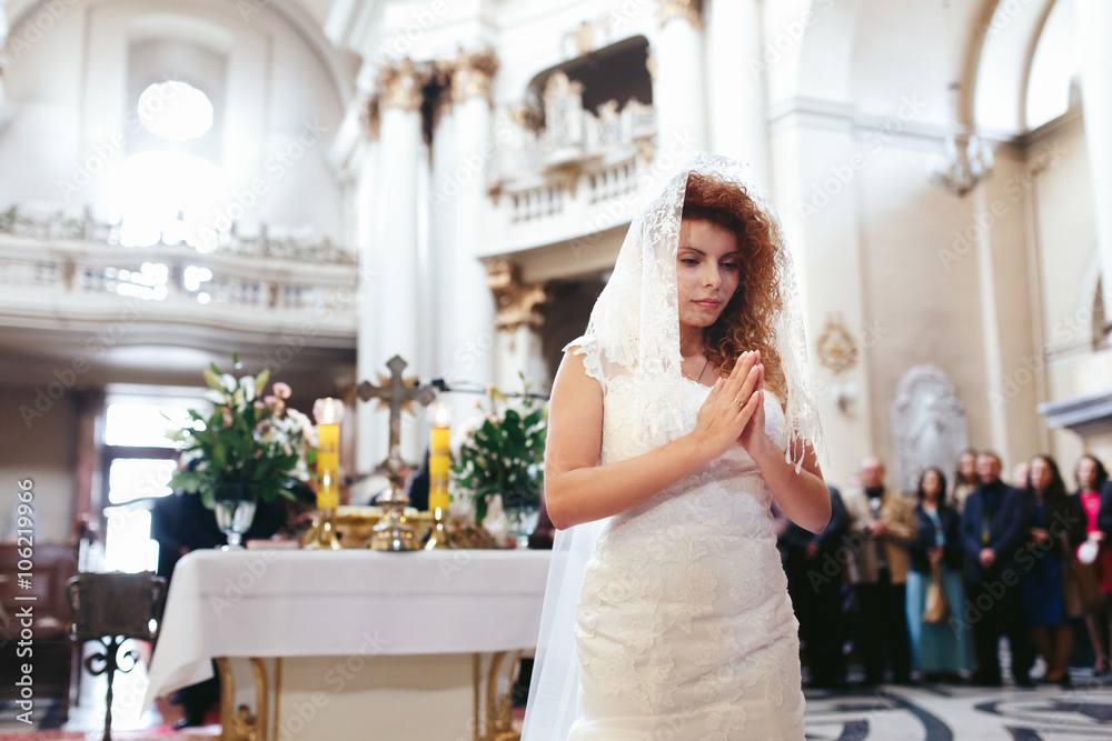 stylish luxury red haired bride prays, wedding ceremony in the o stylish luxury red haired bride prays, wedding ceremony in the o