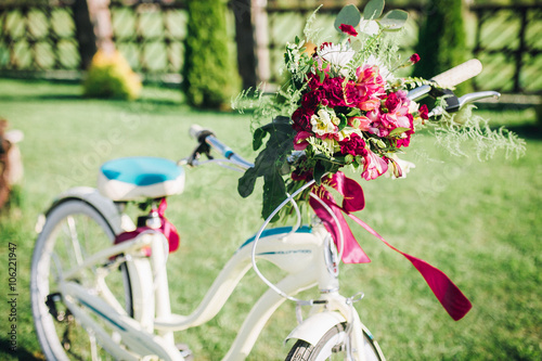 Bouquet of flowers in a bicycle basket