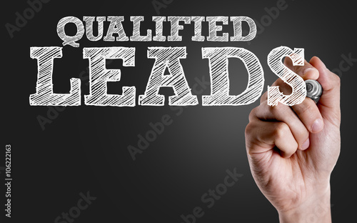 Hand writing the text: Qualified Leads