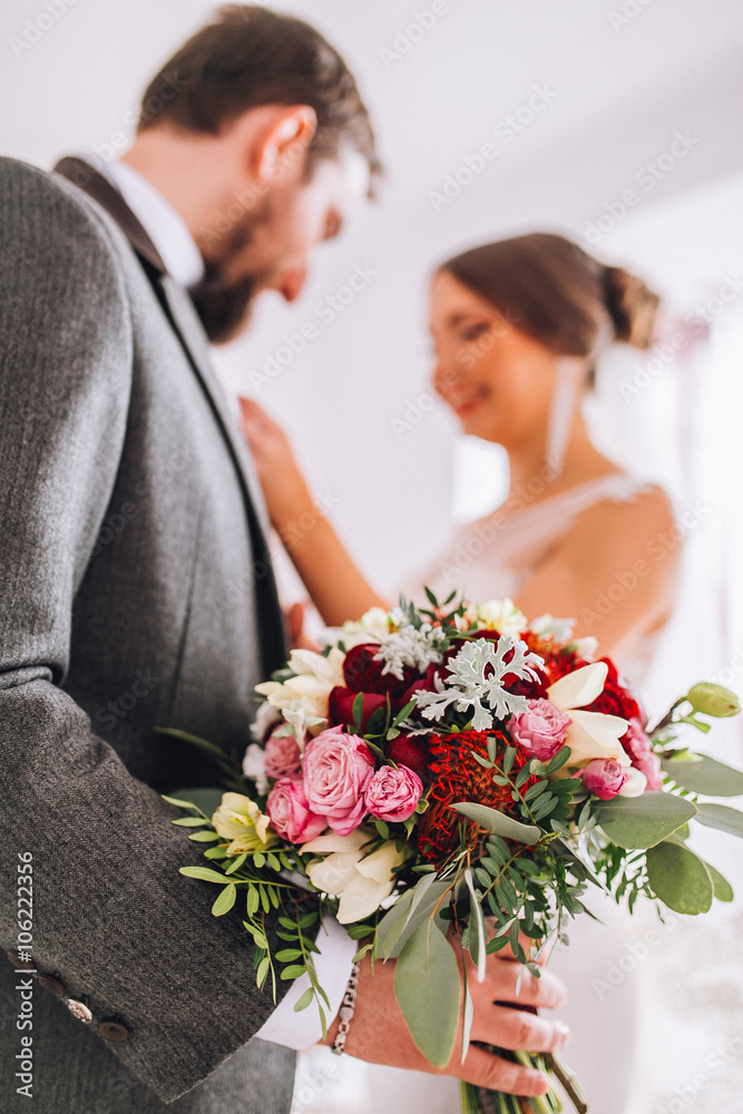 The first meeting of the bride and groom on the wedding day. Emotions newlyweds before the wedding ceremony. Bride and groom look at each other, hugging and kissing. Groom with beard The first meeting of the bride and groom on the wedding day. Emotions newlyweds before the wedding ceremony. Bride and groom look at each other, hugging and kissing. Groom with beard