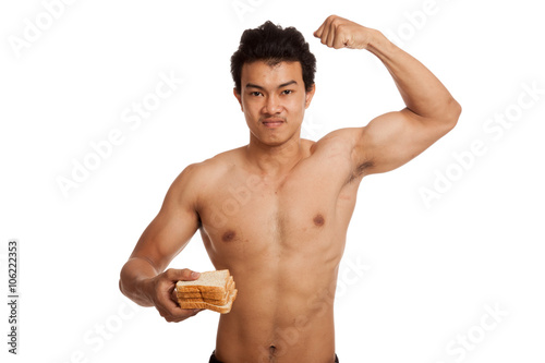 Muscular Asian man load carbs with some bread flexing biceps