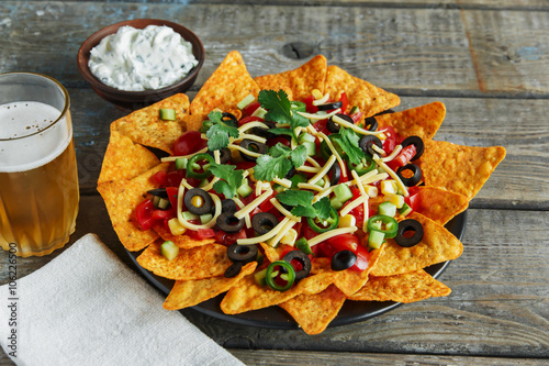  mexican tortilla chips with  cheese  tomato black olives pepper sauce