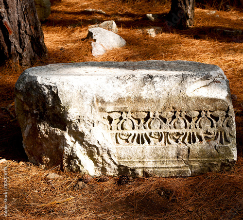 old ruined column and destroyed stone in phaselis temple turkey photo