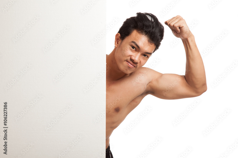 Muscular Asian man  flexing biceps behind  blank sign