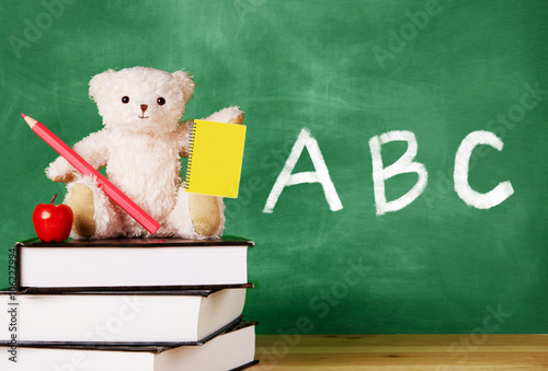 Wallpaper Mural Teddy-bear on the books in front of the blackboard. Abc letters alphabet written on the chalkboard.  Torontodigital.ca