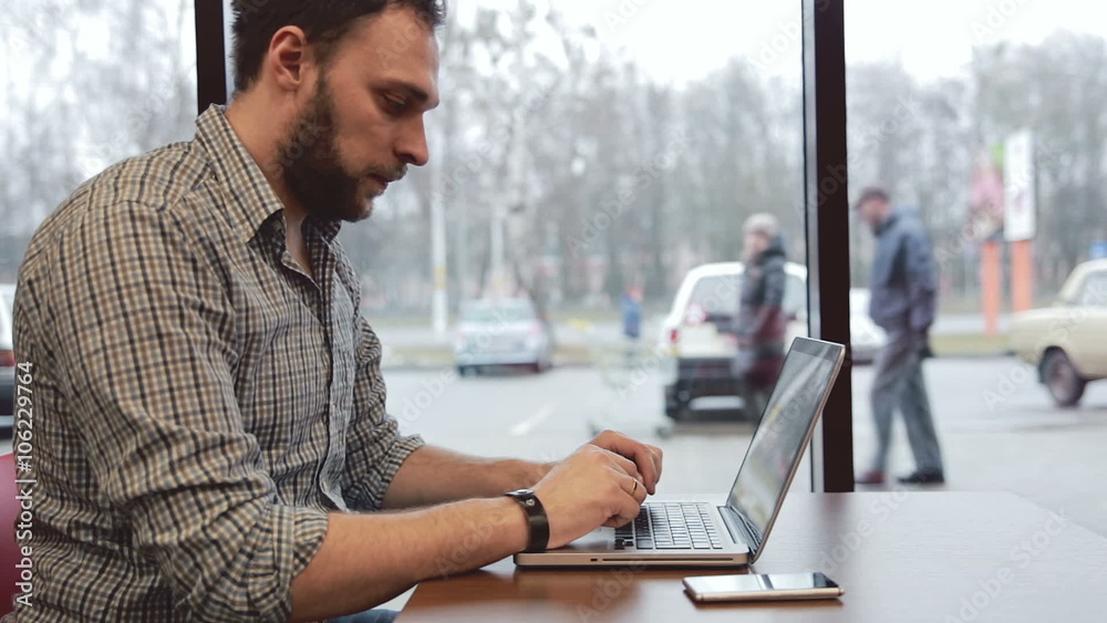 Man working on laptop in cafe. static Man working on laptop in cafe. static