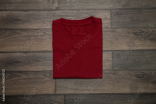 Red blank t-shirt on wooden background