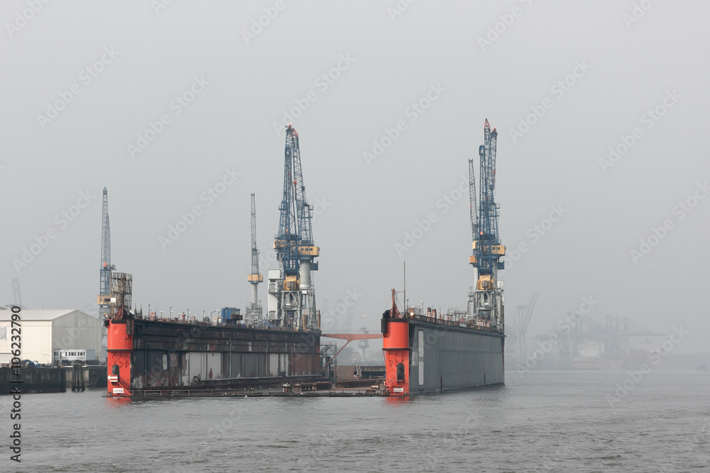 Floating dock in the harbor of Hamburg. Everything is ready for adoption any ship into the dock at the misty morning on the Elbe river.