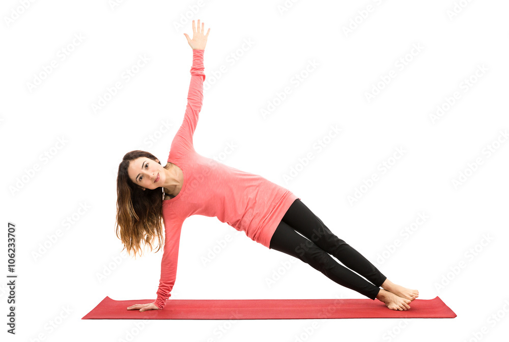 Attractive woman doing side plank pose Attractive woman doing side plank pose