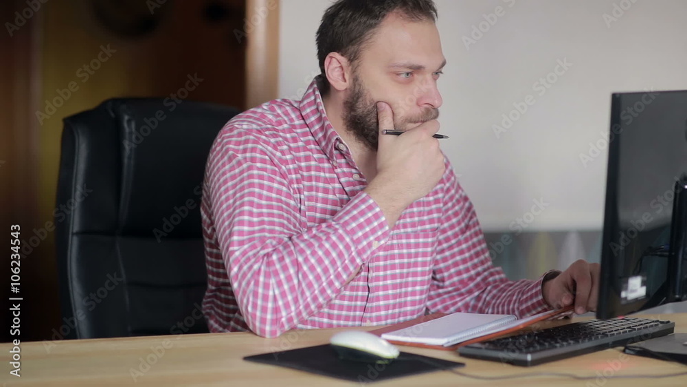 man checked with a diary at the computer man checked with a diary at the computer
