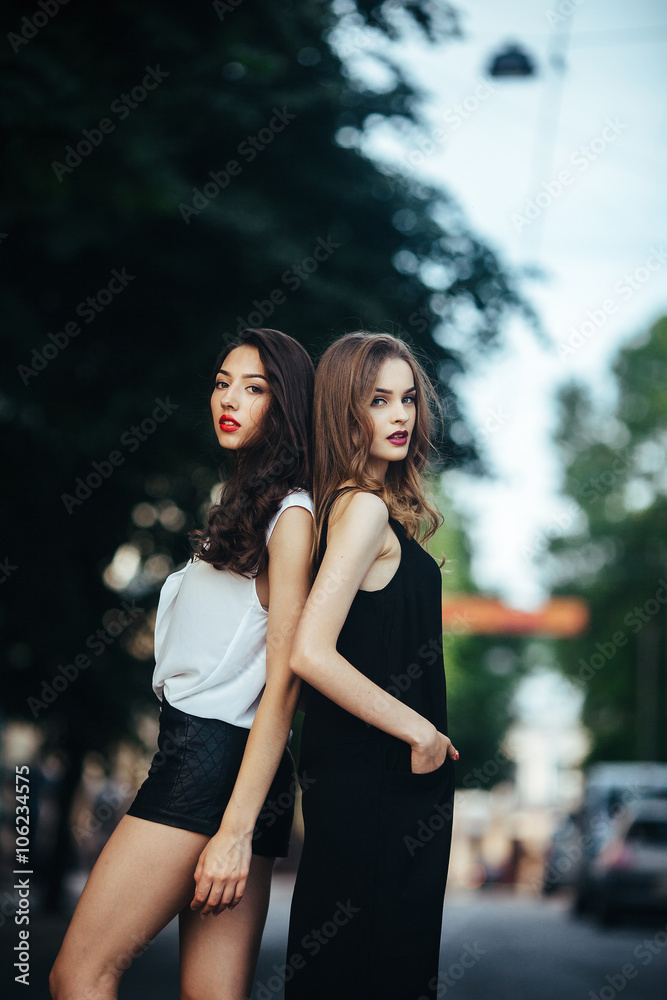 pretty girls posing in a city street