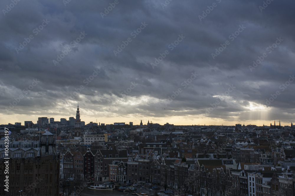 Grey clouds with sun over the european city