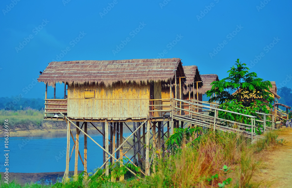 Wooden houses built on high stilts called in Chitwan, Nepal Wooden houses built on high stilts called in Chitwan, Nepal