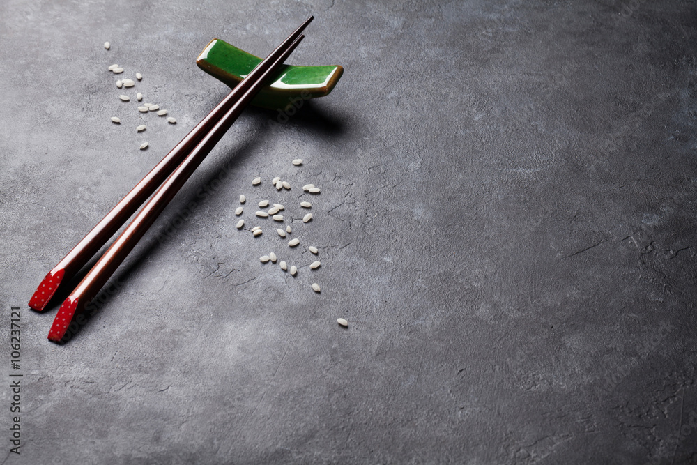 Sushi chopsticks on stone table Sushi chopsticks on stone table