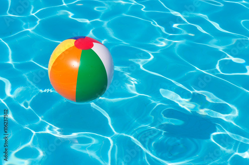 Colorful beach ball floating in a pool