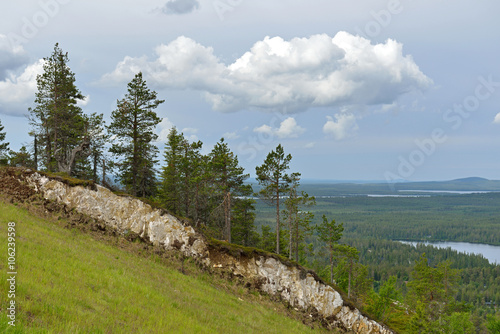 Northern landscape. Mountains, forests and lake in distance