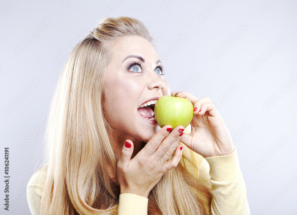 Smiling girl with green apple. Broad smile. Healthy teeth
Smiling girl with green apple. Broad smile. Healthy teeth