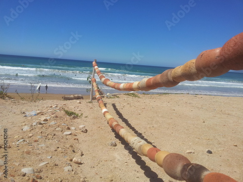 Fishermen's Equipment Rope With Surfers on the Beach photo