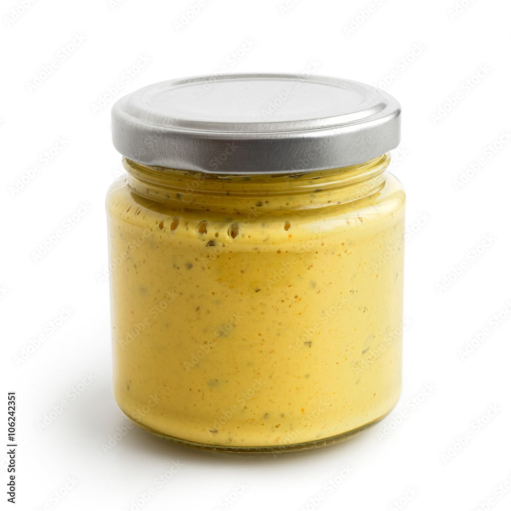 Closed glass jar of yellow curry sauce. Isolated.