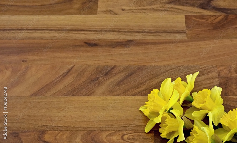yellow daffodils in the corner of the wooden floor yellow daffodils in the corner of the wooden floor