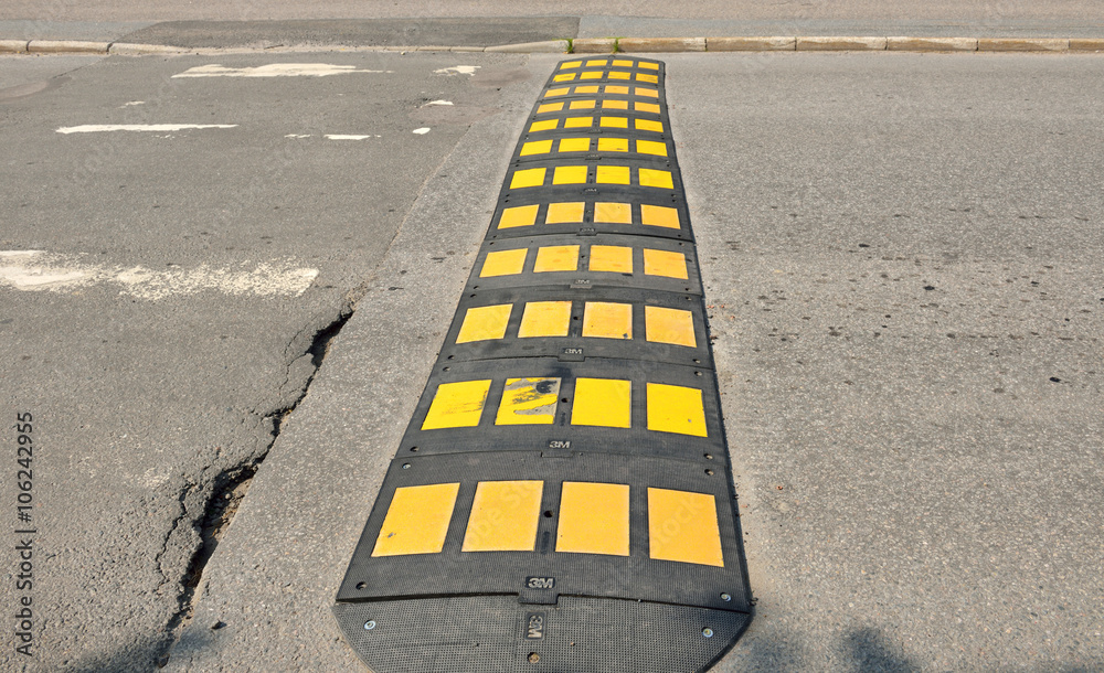 Speed bumps are common name for family of traffic calming devices that use  vertical deflection to slow motor-vehicle traffic in order to improve  safety conditions Stock Photo