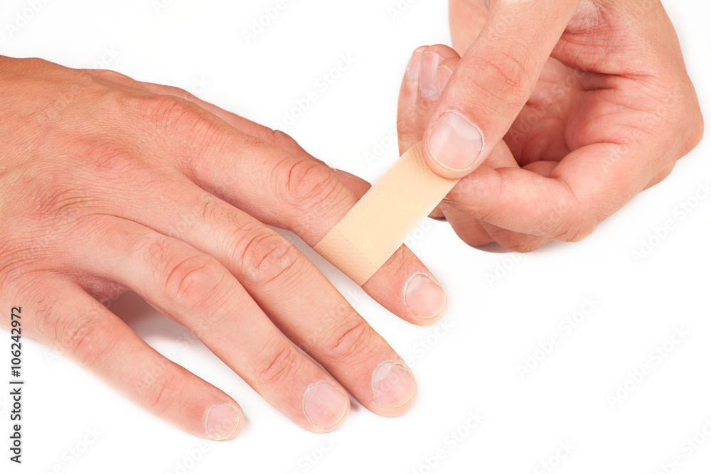 hand putting Adhesive Bandage. band-aid on a cut. isolated on white Stock  Photo