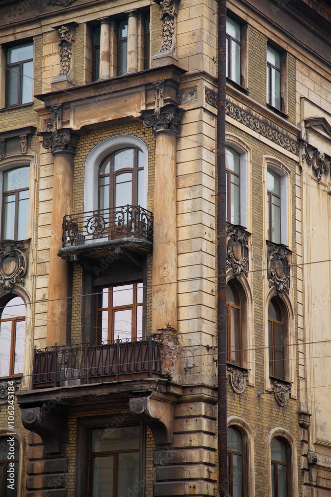 Facade of old corner house with balconies