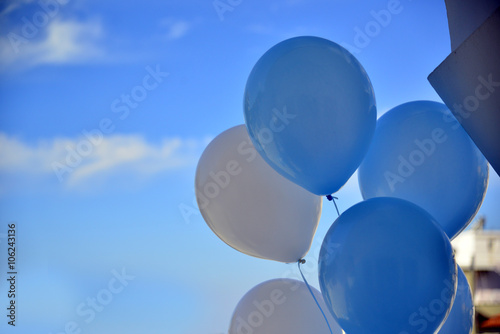 Blue balloons in a blue sky