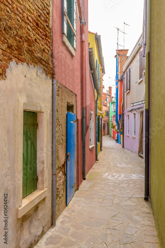 Colorful apartment buildings at very narrow street in Burano  Venice  Italy.