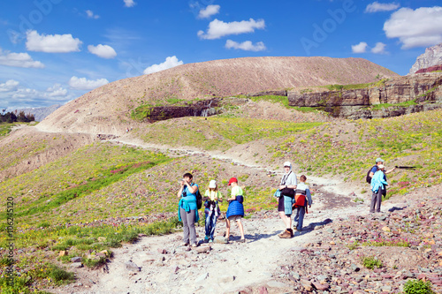 Group of adults with children walk on the trail Group of adults with children walk on the trail to the Hidden Lake