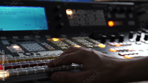 The Hand of an Operator Presses Button and Mix on the Broadcasting Console