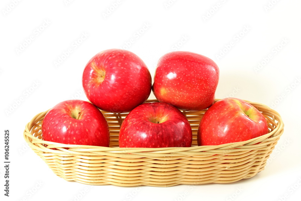 red apple in bamboo basket on white background red apple in bamboo basket on white background
