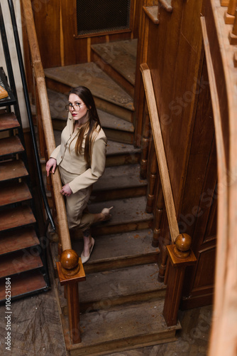 Beautiful stylish lady in suit wallks downstairs photo