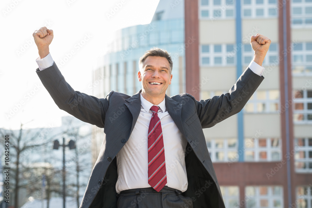 Successful Mature Excited Businessman With Arm Raised