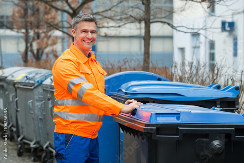 Tableau sur toile Working Man Standing Near Dustbin On Street