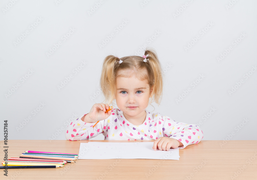 Little girl draws at table pencils. Little girl draws at table pencils.