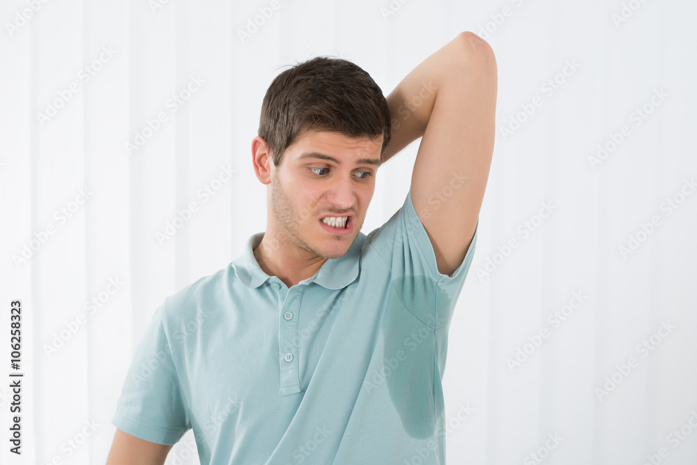 Obraz premium Man Sweating Very Badly Under Armpit