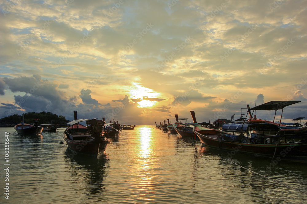 Boats on shore with sunset background