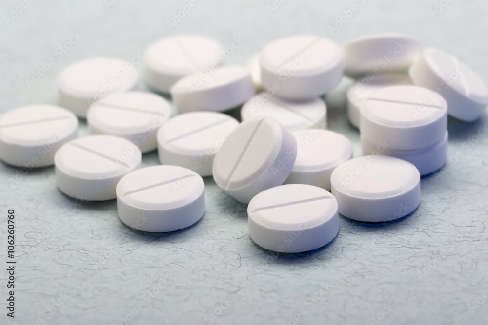 Pile of white round tablets closeup Pile of white round tablets closeup