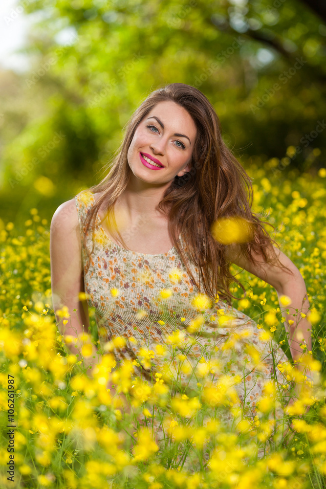 Beautiful young girl among yellow flowers Beautiful young girl among yellow flowers