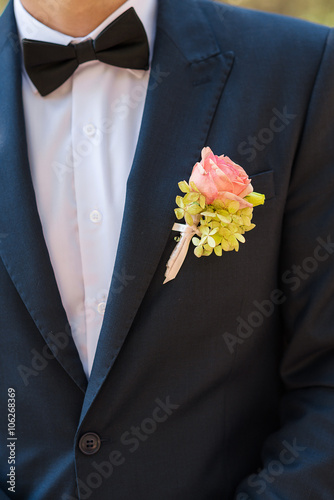 Groom bow tie and boutonniere close up
