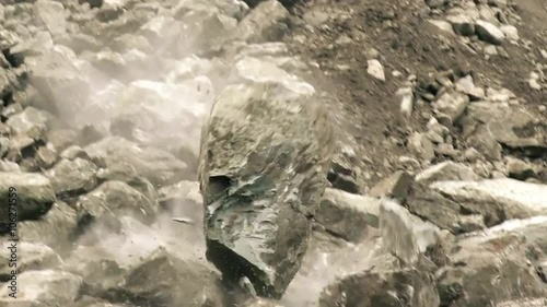 Experience the breathtaking slow motion tracking shot of a massive boulder dramatically descending in front of the camera.