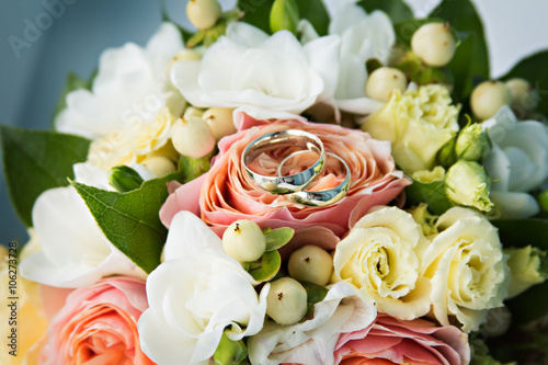 .bridal bouquet and two wedding rings