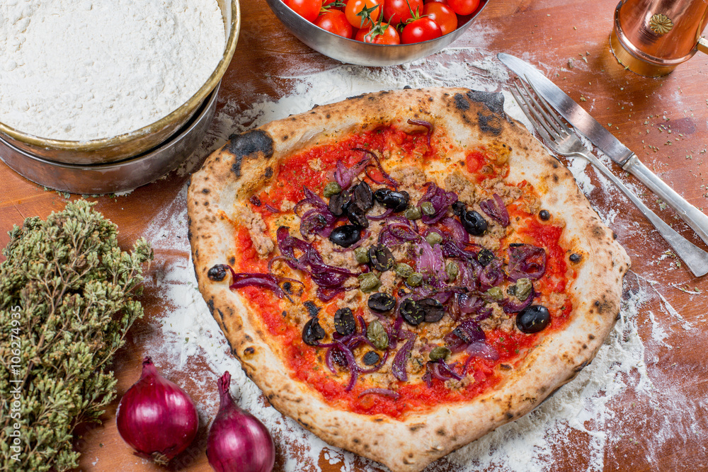 Traditional italian pizza with tuna, onions, caper and olives, o Traditional italian pizza with tuna, onions, caper and olives, o