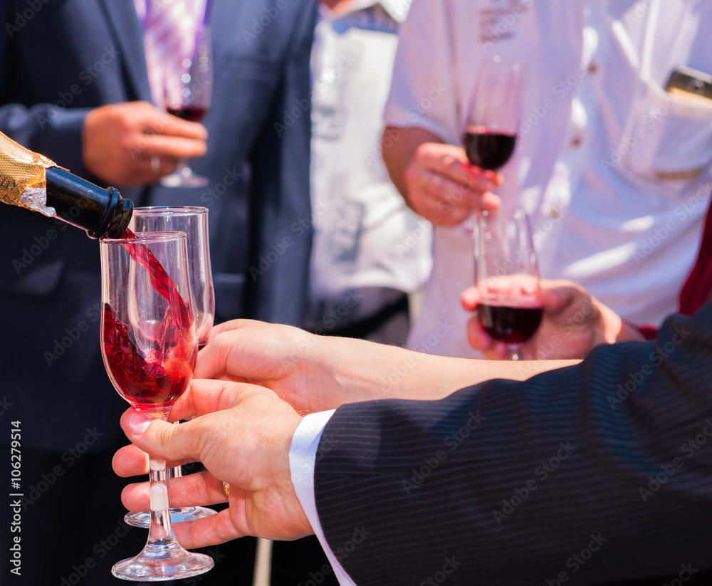 Wine is poured into a glass. Wine is poured into a glass.