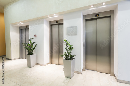 Three elevators in hotel lobby photo