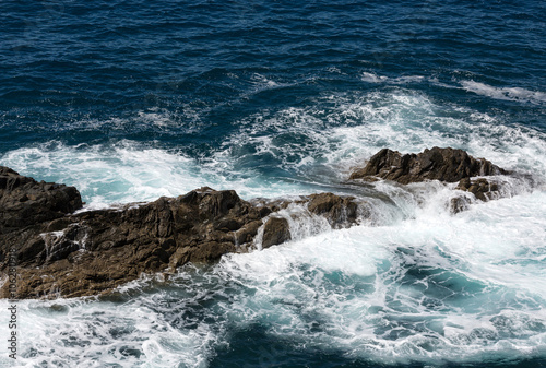 Wave splashing over a rock on Caleta Negra beach in Ajuy on Fuerteventura. Canary Island, Spain